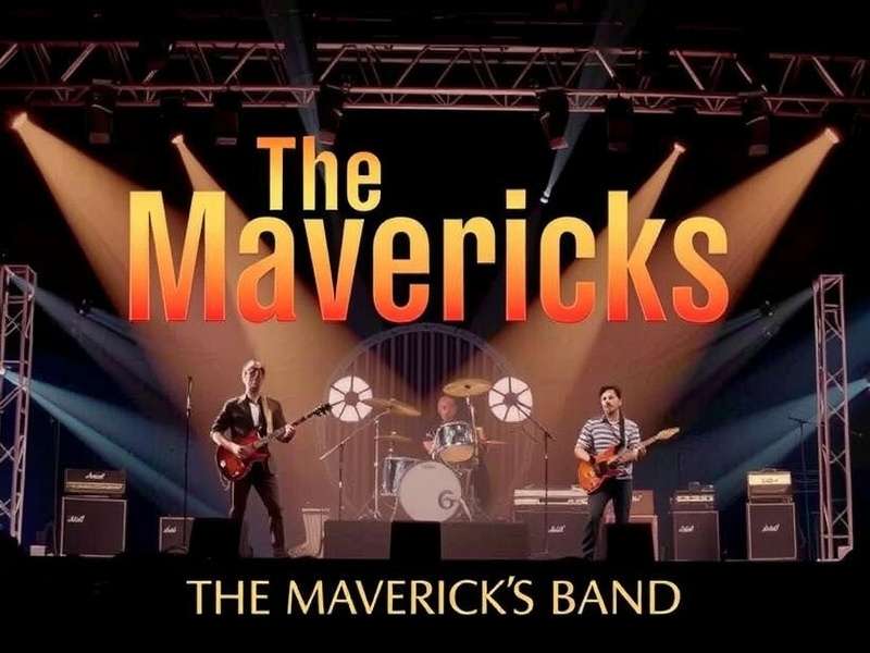 The Mavericks Band performing live on stage at Brixton Academy, London, with dramatic lighting and crowd.